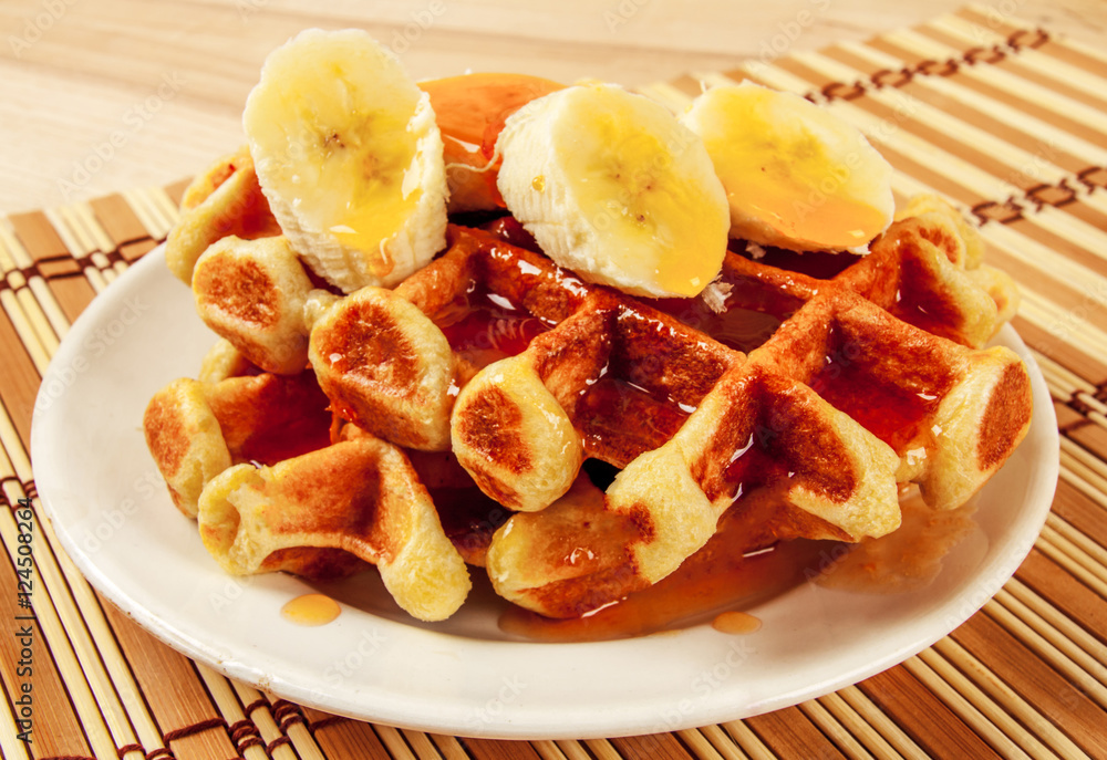 Homemade waffles with orange jam and milk.