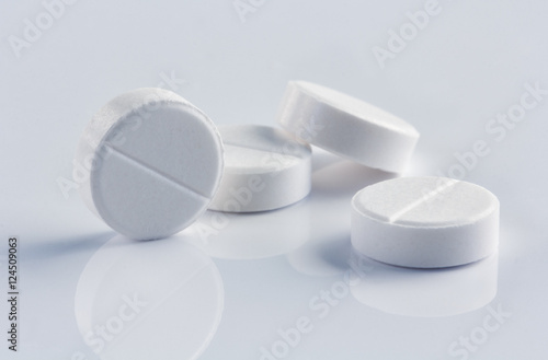white round pills on the white background
