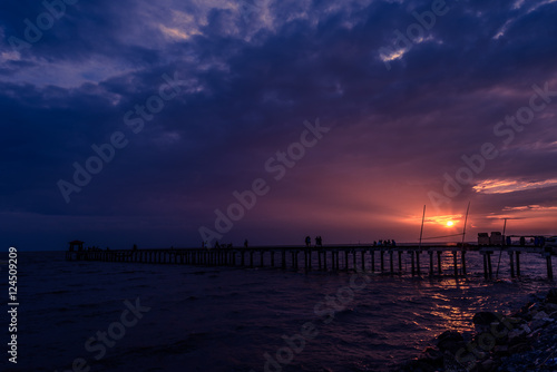 Filed wooden bridge into the sea at sunset in Thailand © 25221501