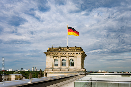 German Reichstag in Berlin, Germany, with national flag, vintage filtered