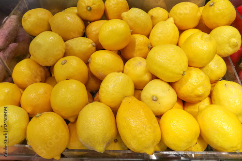 Fresh yellow lemons in the vegetables market.