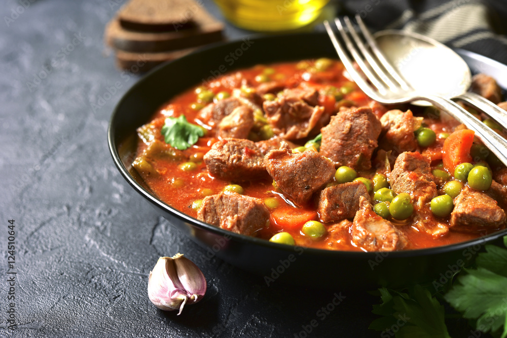 Veal stewed with vegetables in tomato sauce. Veal stewed with vegetables in tomato sauce.