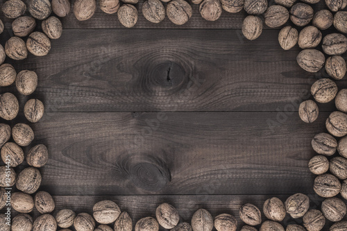 Walnuts on brown wooden table. Image with copyspace.