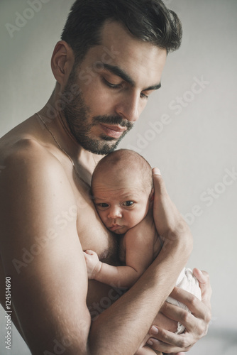 Portrait of loving father with baby at home. Sepia Toned