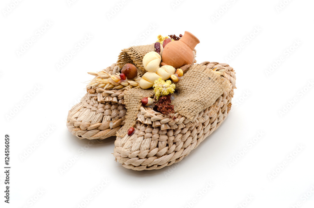Bast shoes with products on a white background. The symbol of hearth and wealth.