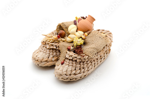Bast shoes with products on a white background. The symbol of hearth and wealth.