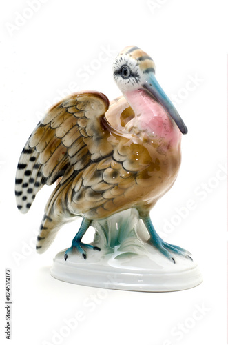 Porcelain bird figurine on white background.
