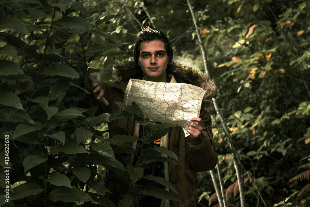 man with map and binoculars expedition through the woods