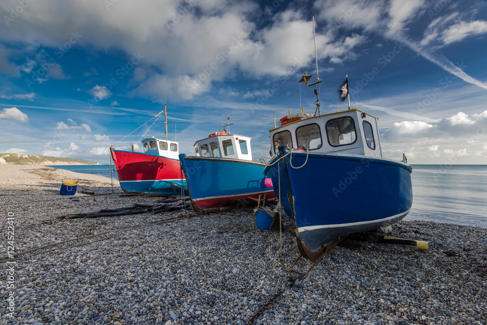 Fiherman boats on pebles at beach in Beer, Devon,UK