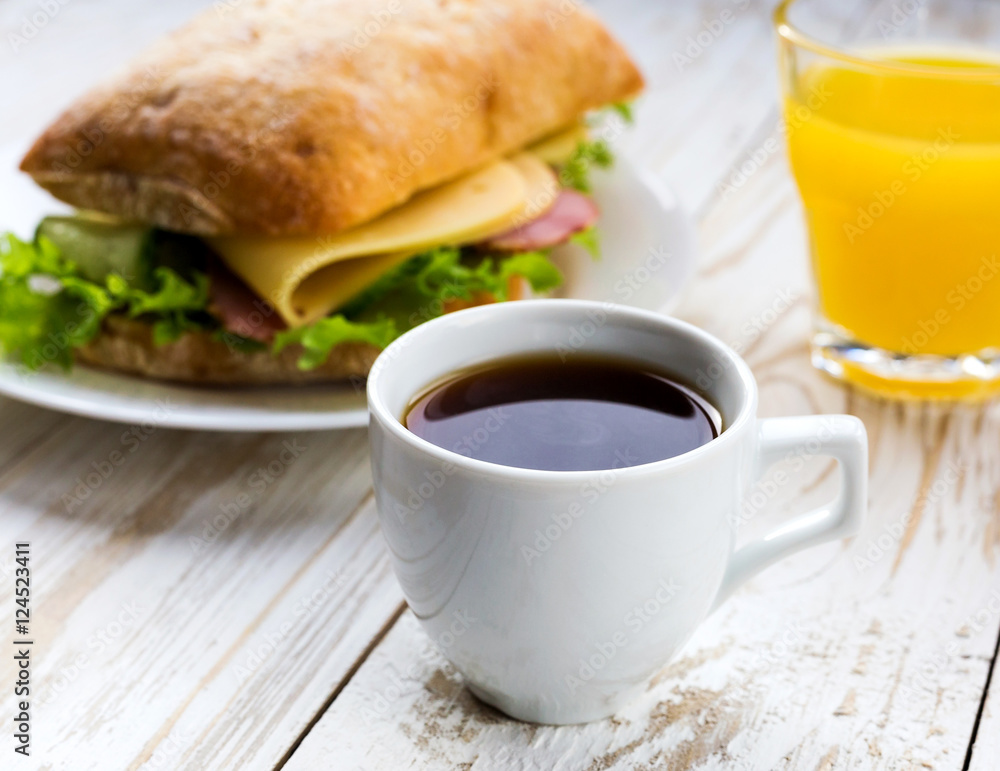 Chiabatta sandwich, cup of coffee and orange juice Chiabatta sandwich, cup of coffee and orange juice