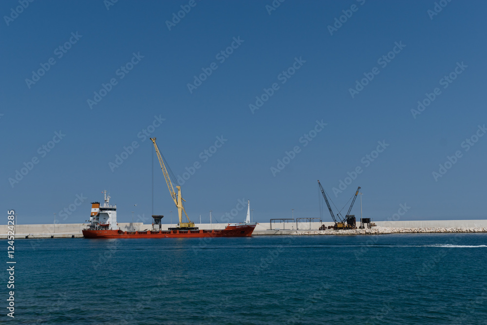 Loading of the container ship in the port of Faro, Algarve, Portugal.