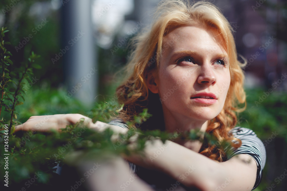 Ginger girl holding hands green branch bush photo toned Ginger girl holding hands green branch bush photo toned