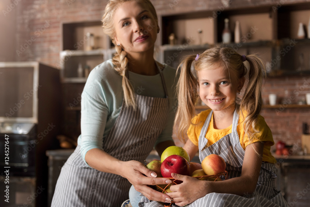 Delighted little girl holding the basket with her mother Delighted little girl holding the basket with her mother