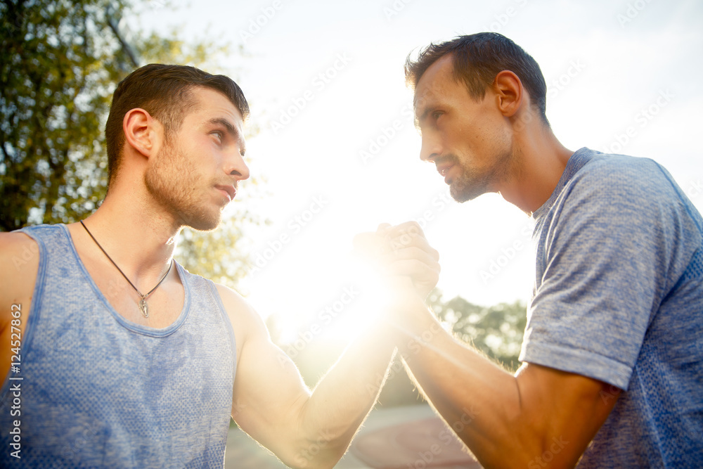 Two male athlete handshake outdoors Two male athlete handshake outdoors