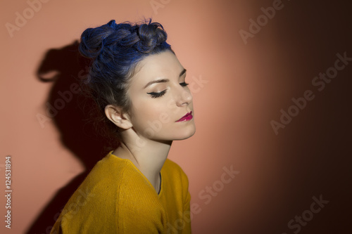 Portrait of beautiful girl with blue hair in the studio