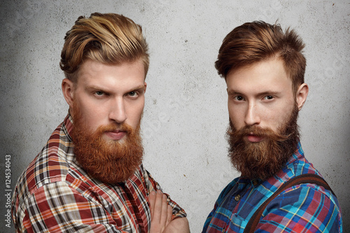 Fotografie, Tablou Two handsome young unshaved men with hipster beards dressed in stylish checkered