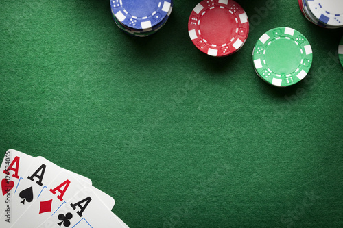 Poker background - chips and cards on green table photo
