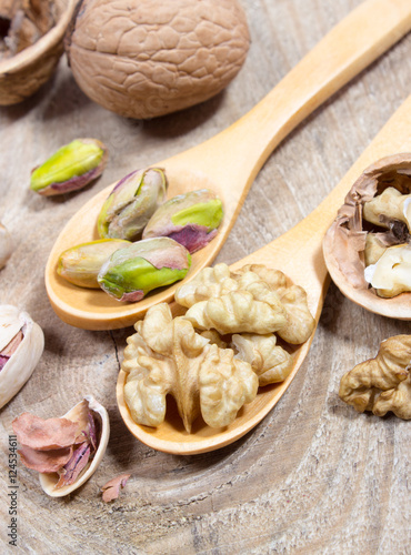 Closeup of a walnut and pistachios.