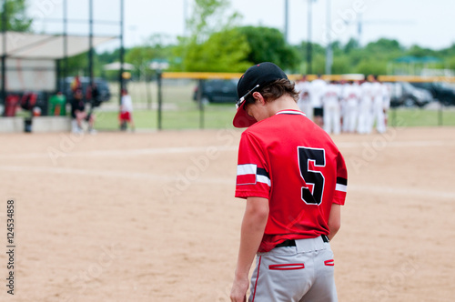 Teen baseball player from behind
