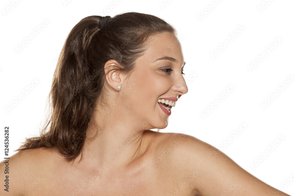 Profile of smiling young woman with a pony tail Profile of smiling young woman with a pony tail