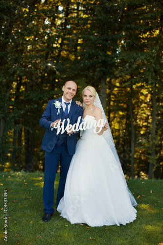 Newlyweds holding letters walking © lanser314