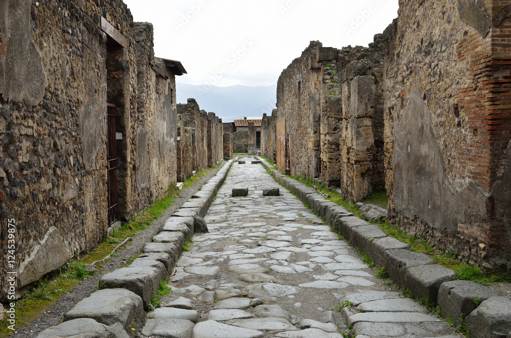 Restored street in the ancient Pompeii Restored street in the ancient Pompeii