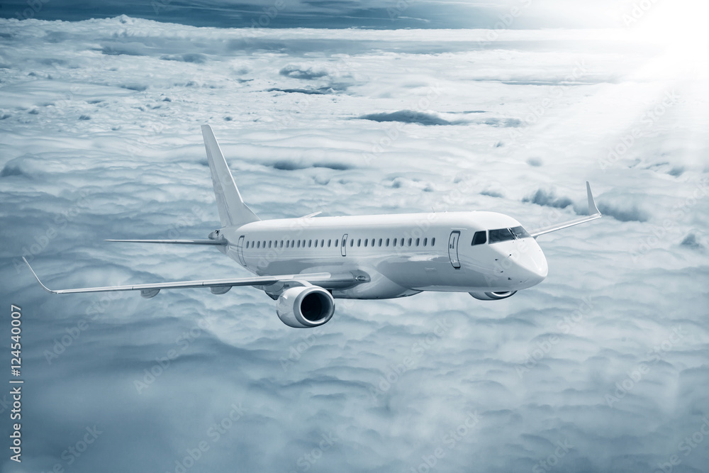 Fototapeta premium White airplane flying higher clouds at daytime