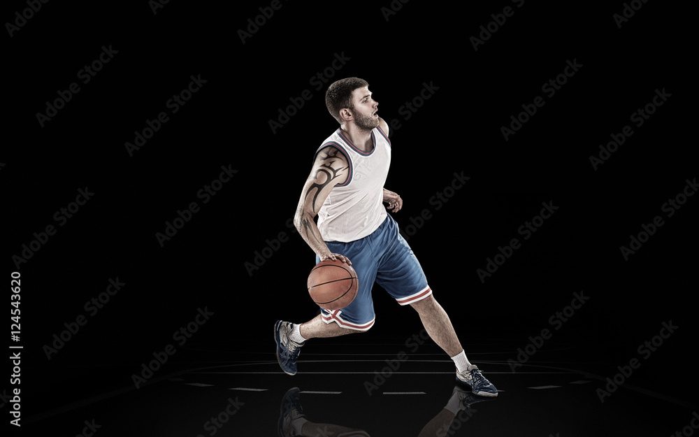 Caucasian basketball player with ball isolated on a black background Caucasian basketball player with ball isolated on a black background