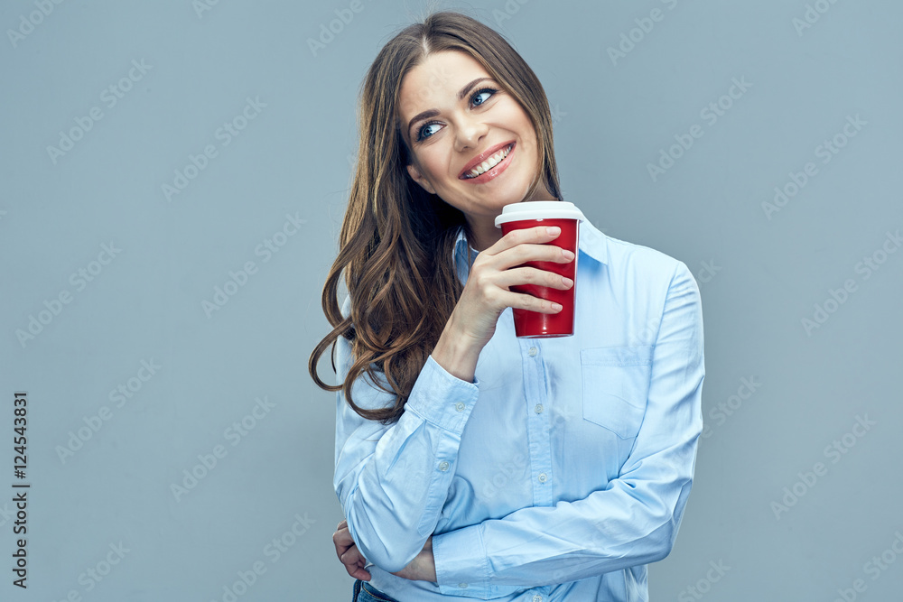 Smiling business woman holding red coffee glass looking to side. Smiling business woman holding red coffee glass looking to side.