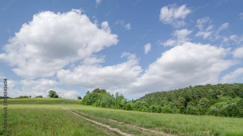 Clouds moving over green field and country tourist road - Time lapse - 4K 3840 x 2160 Clouds moving over green field and country tourist road - Time lapse - 4K 3840 x 2160