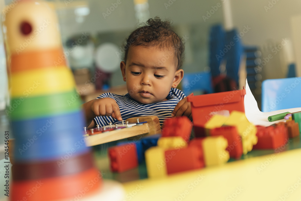 Happy baby playing with toy blocks. - obrazy, fototapety, plakaty 