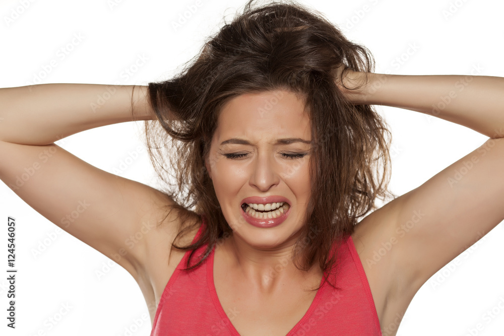 portrait of nervous young woman with itching in her hair portrait of nervous young woman with itching in her hair