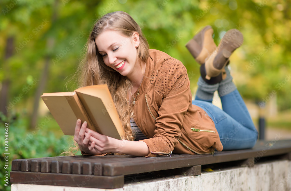 Beauty woman reading a book in the park Beauty woman reading a book in the park