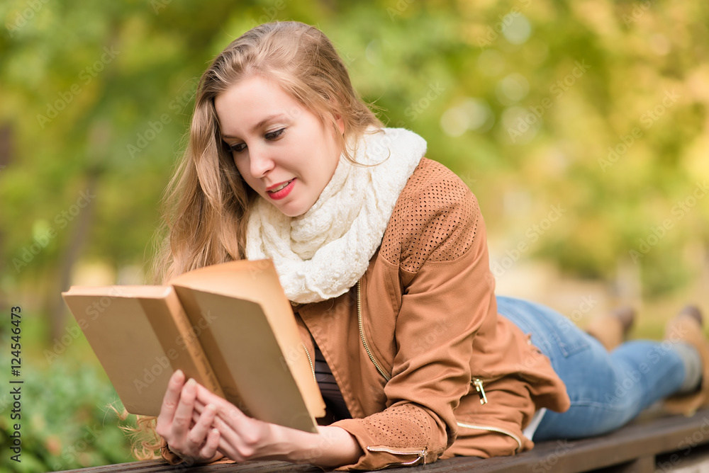 Beauty woman reading a book in the park Beauty woman reading a book in the park
