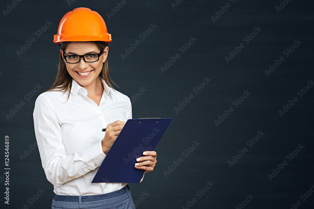 Woman architect writes on clipboard. Woman architect writes on clipboard.