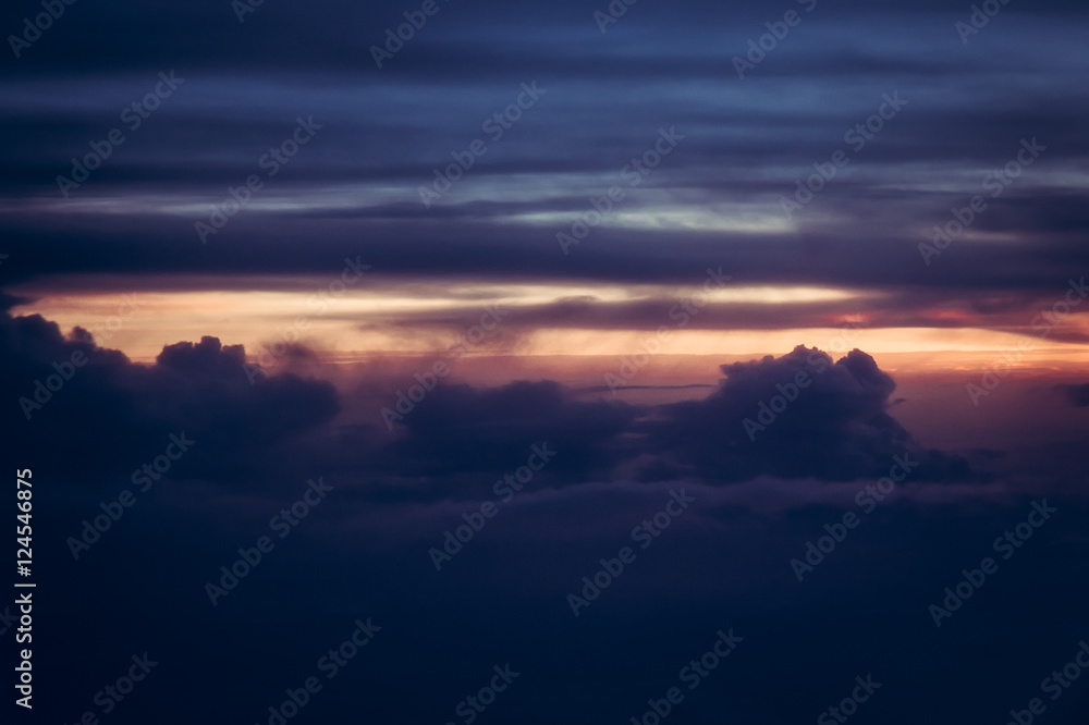 Dramatic sunset sky with dark clouds and sunlight on horizon
