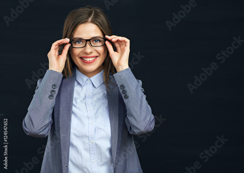 Smiling business woman touching her glasses.