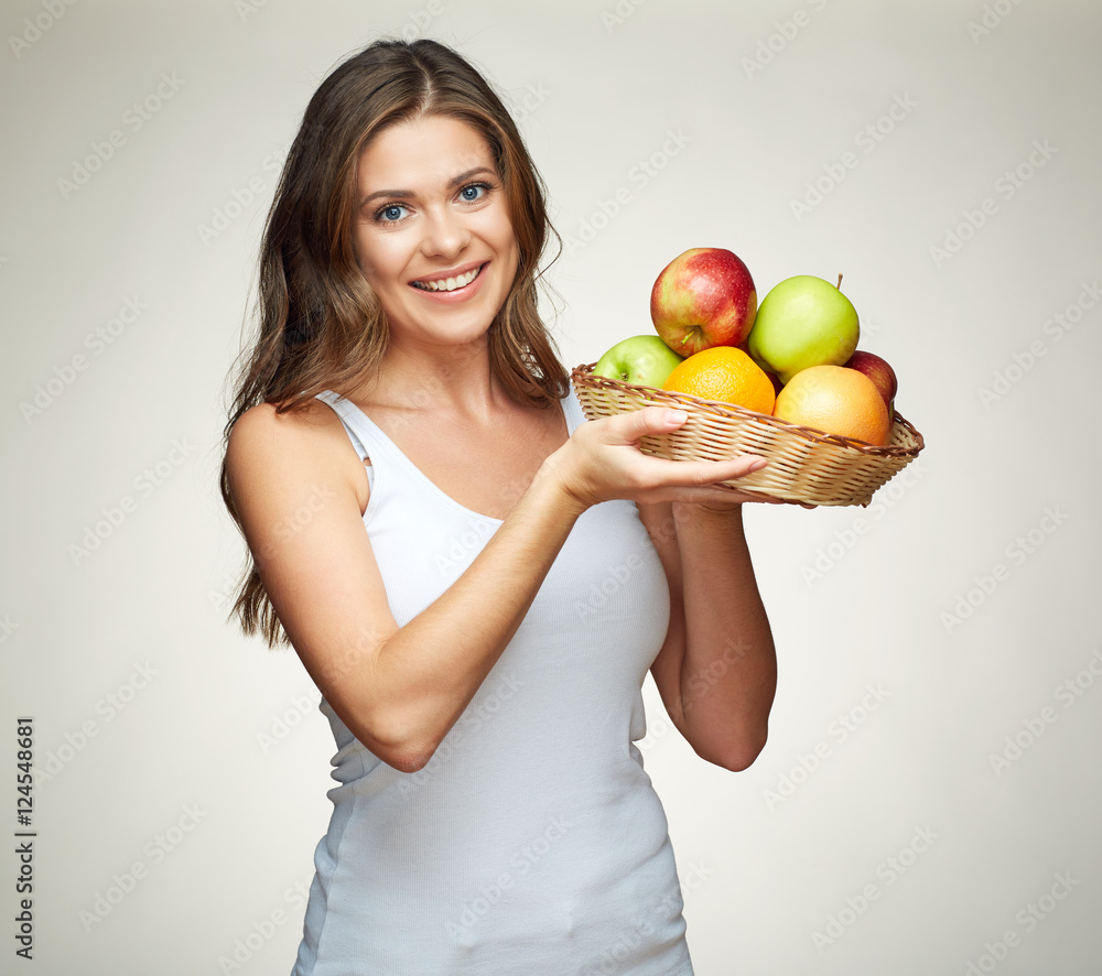 Smiling woman holding straw basket with fruits. Smiling woman holding straw basket with fruits.