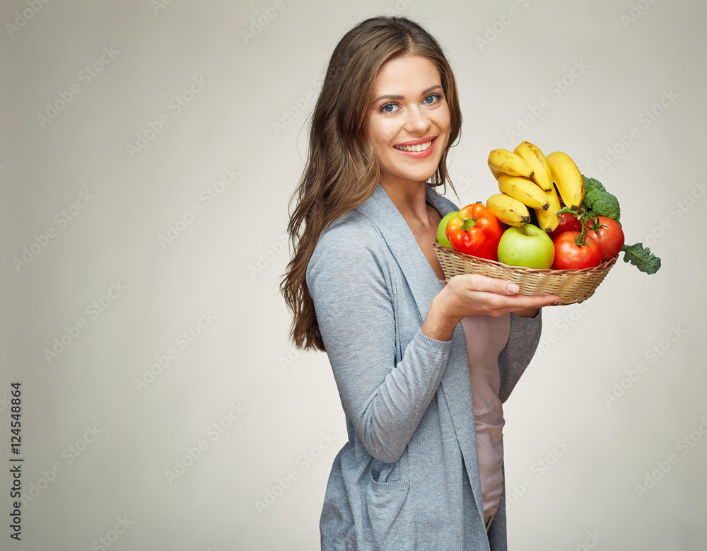 smiling woman holds straw basket with healthy food smiling woman holds straw basket with healthy food