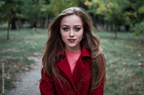 portrait of beautiful girl with blue eyes in red