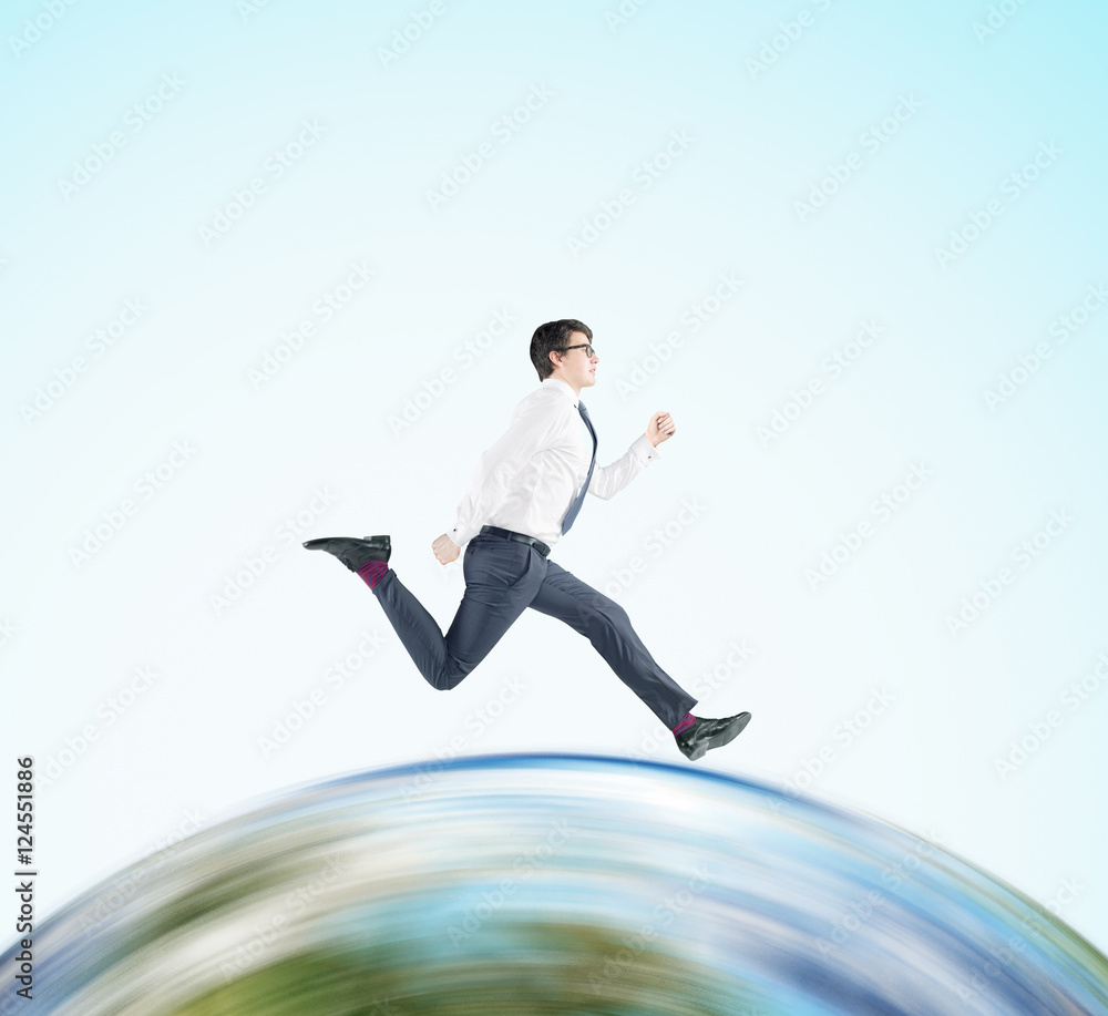 Businessman running on the globe Businessman running on the globe