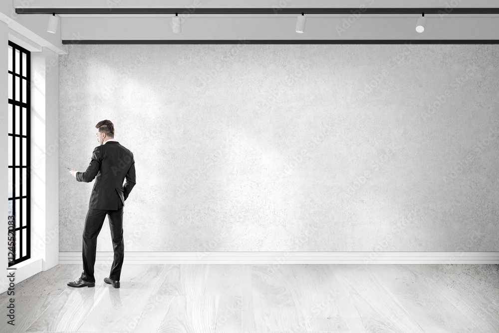 Obraz premium Man with cell phone is calling from empty office