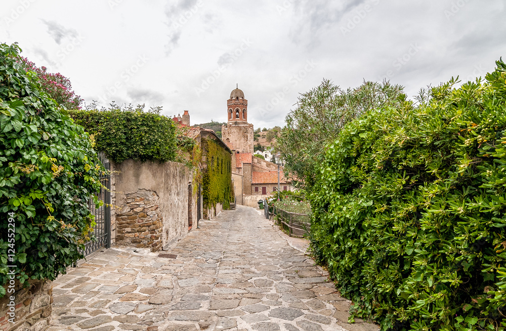 The street with San Giovanni Battista Church in background in Castiglione della Pescaia, Tuscany, Italy