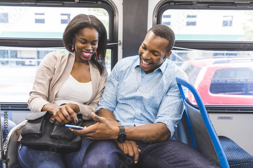 Happy black couple travelling by bus in Chicago