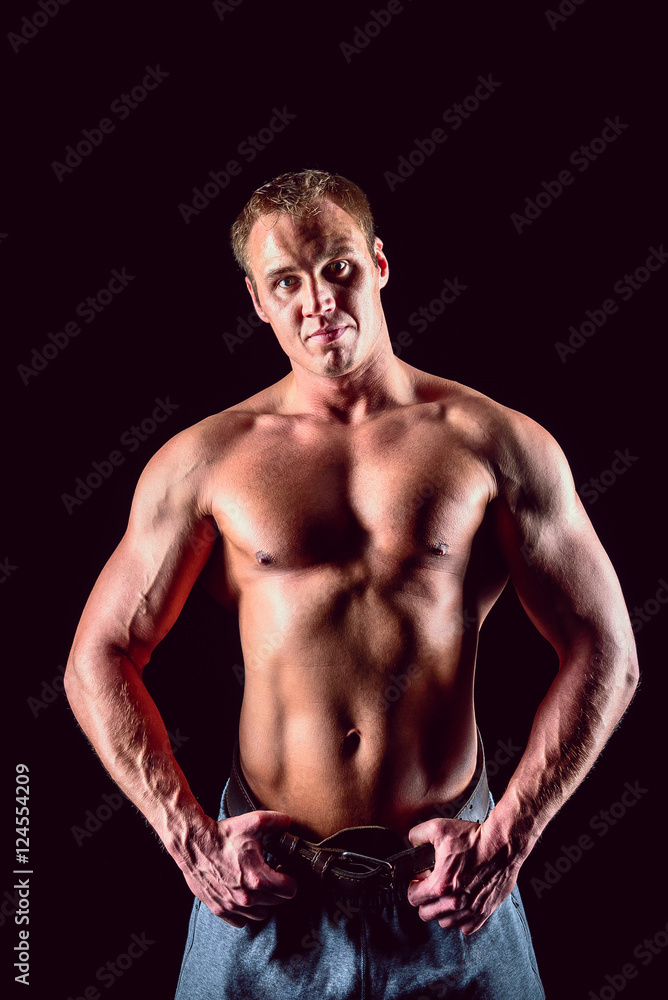 Muscular man with dumbbells on black background Muscular man with dumbbells on black background