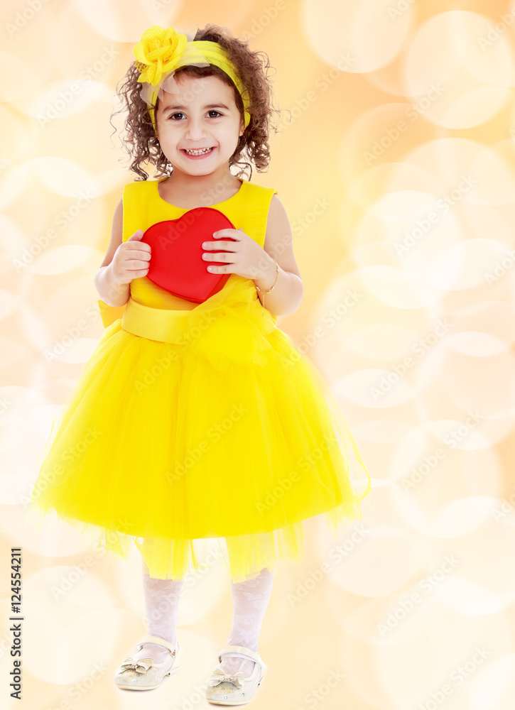 Cute little girl holds heart