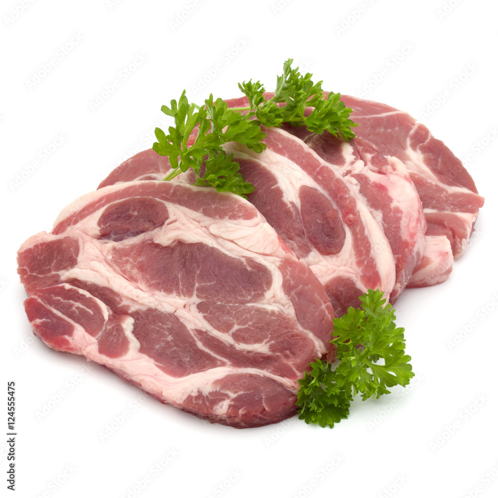 Raw pork neck chop meat with parsley herb leaves garnish isolate
