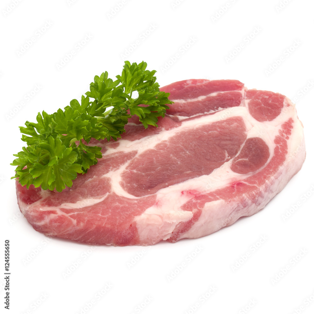 Raw pork neck chop meat with parsley herb leaves garnish isolate Raw pork neck chop meat with parsley herb leaves garnish isolate