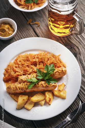 Baked Munich  sausages with stewed cabbage and a glass of beer