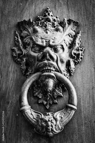 Door knoker on an old wodden door. photo